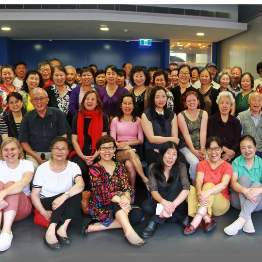 English Class students and volunteer tutors. A group of happy smiling people.